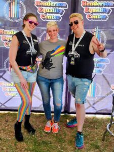 Dev, Tammi, and Zak are posing in their summer gear at the Southern Nevad Pride festival.